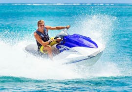 A man is riding a jet ski in Kavos with Asprokavos Watersports.