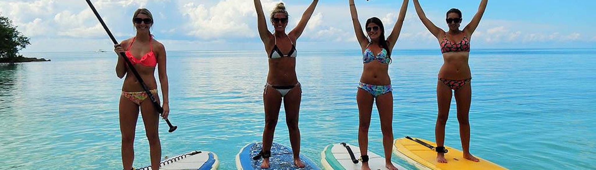 A group of women go stand up paddling in Kavos with Asprokavos Watersports.