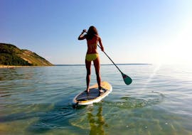 A woman is paddling on a SUP in Kavos provided by Asprokavos Watersports.