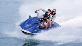 A man and a woman are whizzing across the water on a jet ski hired from Adventure Croatia.