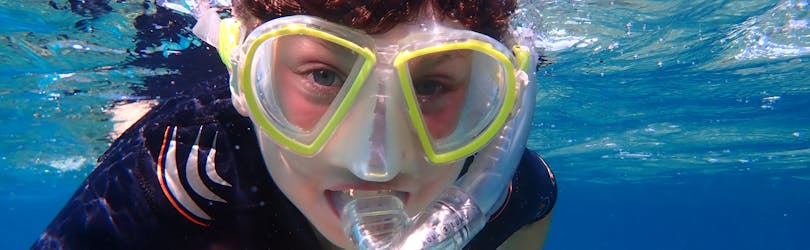 A young boy during his Snorkeling Trip to Cala Delta Nature Reserve from El Arenal with Diving and Adventure Mallorca.