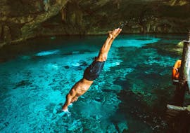 Man plunging in the Blue Cave during our 4 Islands Boat Trip incl. Blue Caves with Swimming with Toto Travel. 
