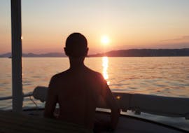 A man is watching the sunset while on a Private Catamaran Trip in the Bay of Juan-les-Pins with SeaZen.