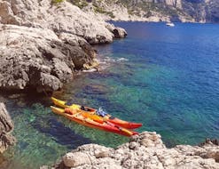 A group of people can be seen on their sunset sea kayaking trip to the Goudes with swimming with 123 Kayak.