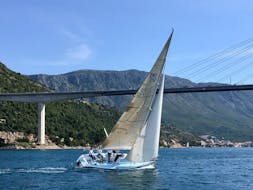A race sailing boat navigates in Dubrovnik & Elaphiti Islands with The Day Sail Croatia.