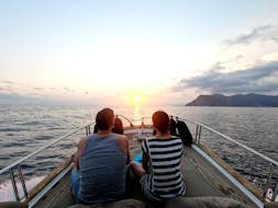Two people enjoying the sunset boat trip from Levanto to Cinque Terre with Costa di Faraggiana Levanto.