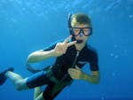 A kid goes on a snorkeling trip in Agios Nikolaos Bay with Pelagos Dive Center in Crete.