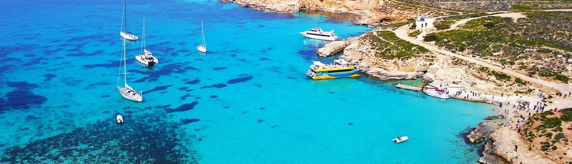 Holidaymakers are enjoying the view during their catamaran tour of the Blue Lagoon, Comino and Gozo organised by Sea Adventure Excursions.