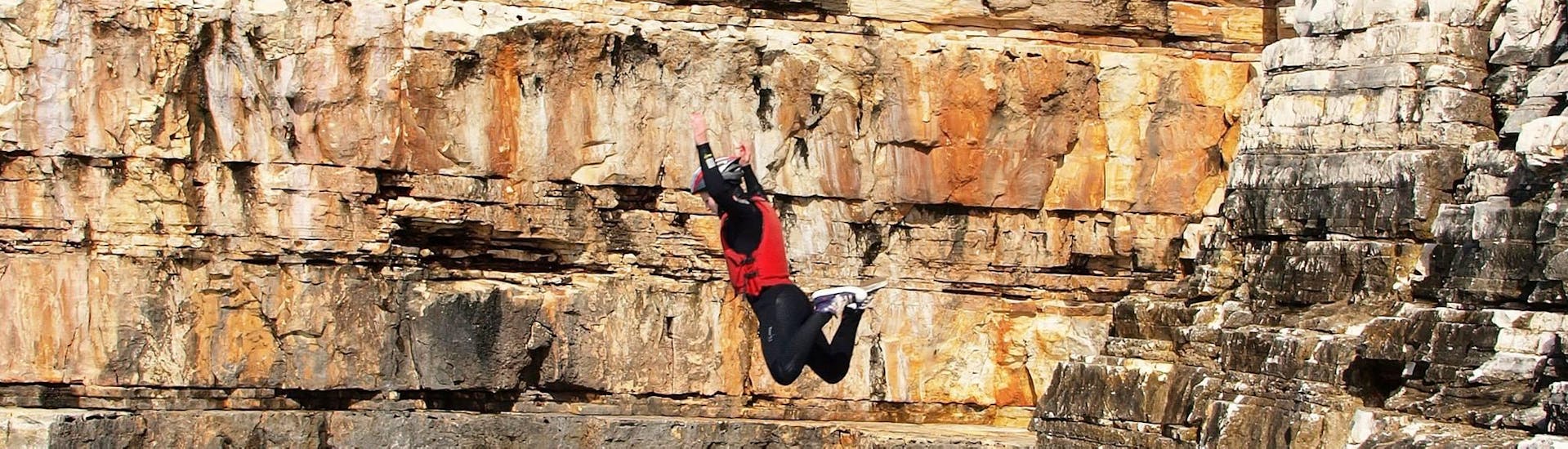 A woman goes a Coasteering adventure in Pula Bay with Pula Outdoor.