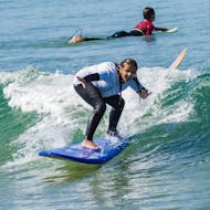 A young girl from the Gecko Surf School surfs on the Costa da Caparica.