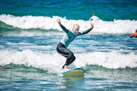 A girl does surfing lessons in Peniche with Silver Coast Surf School.