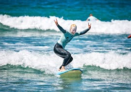 A girl does surfing lessons in Peniche with Silver Coast Surf School.