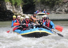 A group of rafters is paddling along the river during their Half-Day Rafting on the Salzach River in Taxenbach with Rafting Center Taxenbach.