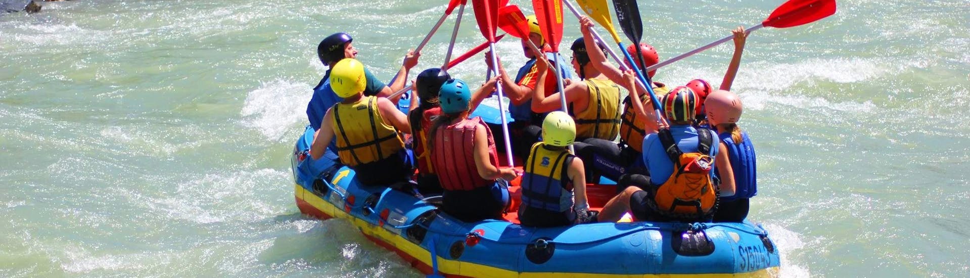 During the Rafting for Kids & Families on Salzach River in Taxenbach, a group of kids with their families is having fun on the river thanks due to their guide from Rafting Center Taxenbach.