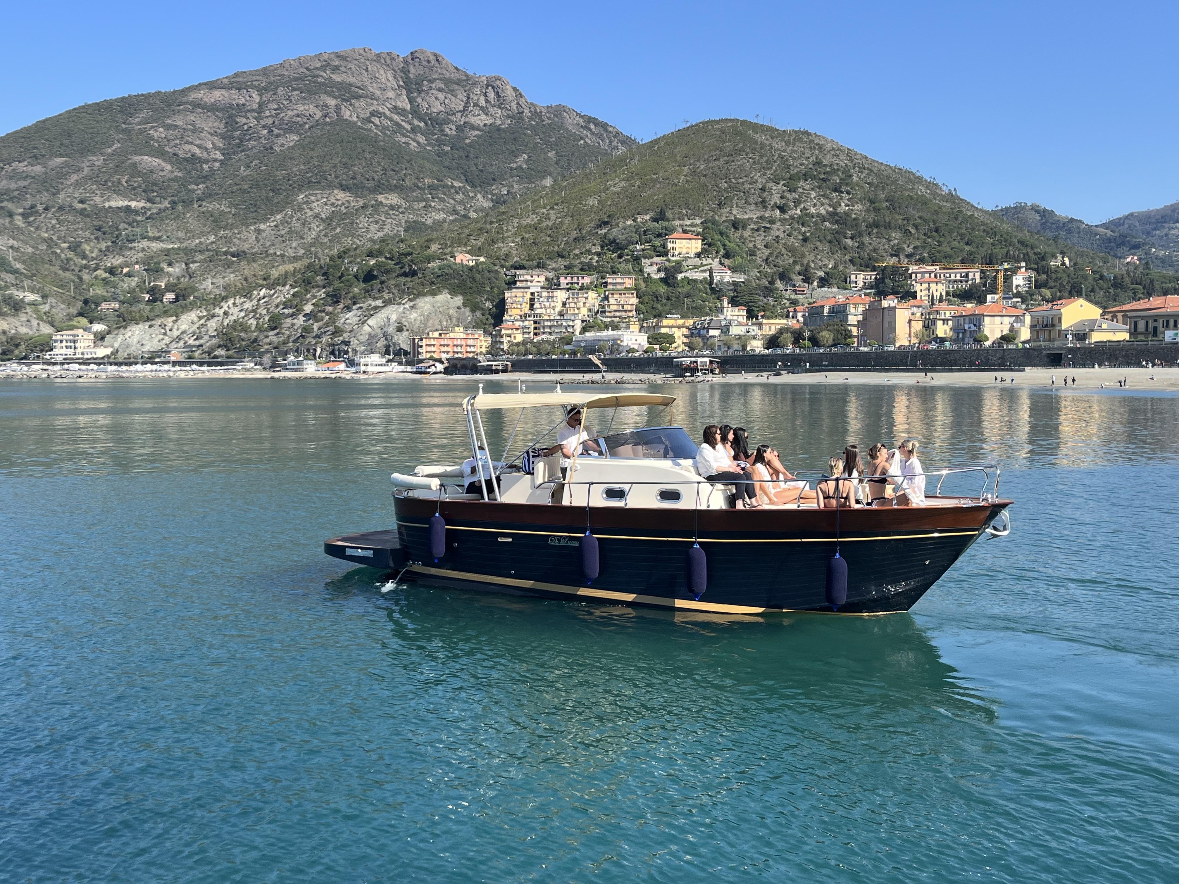 Private boat trip along the coast of Levanto Guests enjoy a private boat trip to Portofino & San Fruttuoso from Levanto on a classic boat from Costa di Faraggiana Levanto, cruising past the scenic coastline on a sunny day.