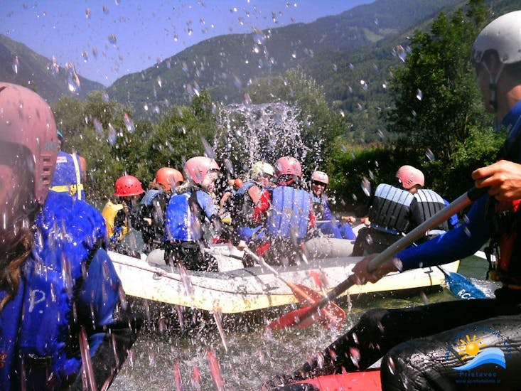 Several boats and people of the Sporterlebnis Camp Pristave Obervellach rafting on the Möll in Carinthia. 