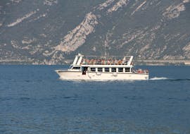 The boat is crossing the Lake Garda on its way from Limone to Malcesine