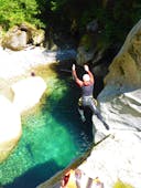 A brave participant of the canyoning in Zemmschlucht - Blue Lagoon Light with Freiluftakademie Zillertal jumps into the clear water of the gorge.