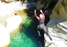 A brave participant of the canyoning in Zemmschlucht - Blue Lagoon Light with Freiluftakademie Zillertal jumps into the clear water of the gorge.