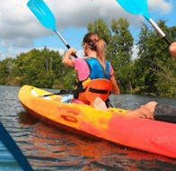 A couple is paddling on the river leading to the sea during the Sea Kayak Rental - Côte des Nacres offered by Acqua et Natura.