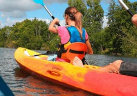 A couple is paddling on the river leading to the sea during the Sea Kayak Rental - Côte des Nacres offered by Acqua et Natura.