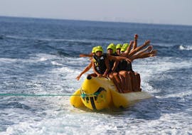 A group of people have fun during a banana boat ride in Costa Blanca with Baliser Mar. 