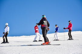 Ski instructor from YES Academy Sestriere with kids on the slopes during ski lessons for skiers with experience.