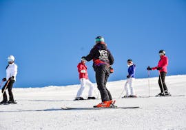 Ski instructor from YES Academy Sestriere with kids on the slopes during ski lessons for skiers with experience.