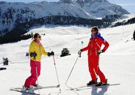 An instructor from the ESF Courchevel 1650 and a skier have a good time during a private ski lesson for adults.