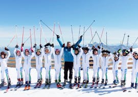 A group of happy kids during the kids ski lesson with Scuola di Sci Monti della Luna San Sicario.