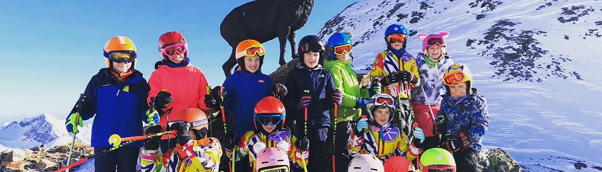 Ski instructor with participants in Gressoney during one of the Kids Ski Lessons (5-15 y.) for All Levels.
