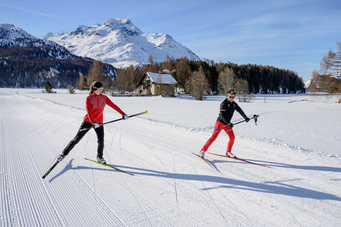 A cross-country skier is learning the classic technique during private cross-country skiing lessons with Swiss Ski School St. Moritz the Red Legends.