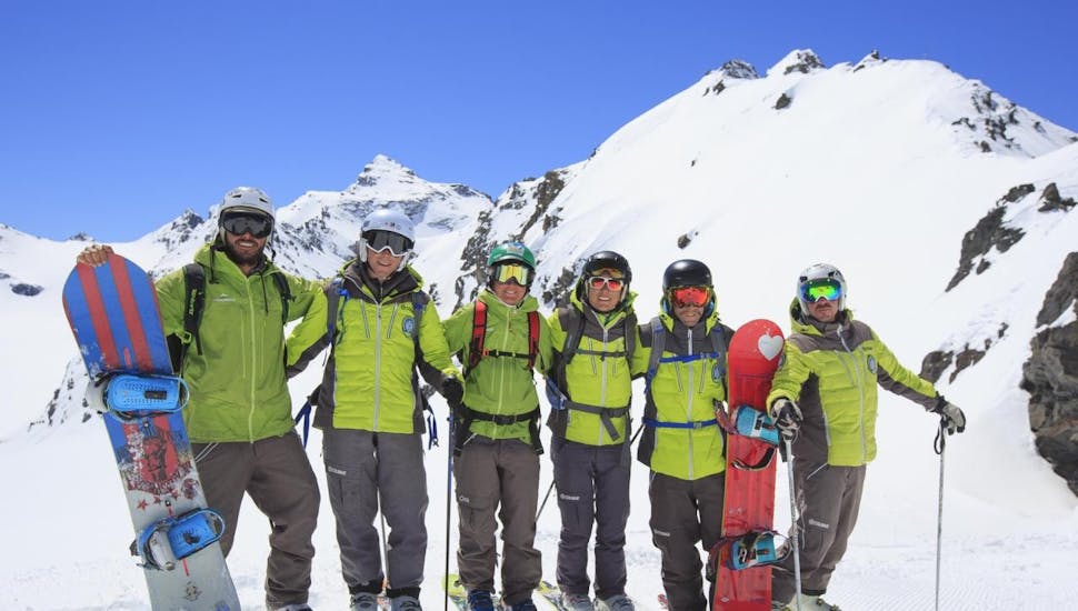 Snowboarders are taking a picture during their Adult Snowboarding Lessons for All Levels with Prosneige Alpe d'Huez.