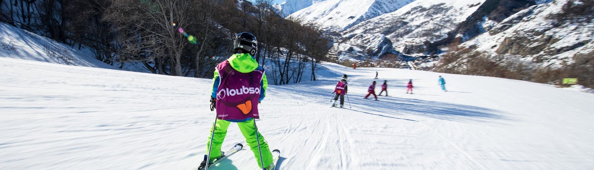 A group of skiers on the slopes of Les Ménuires during a kids ski lesson for 5 to 13 year olds with the ESI Ski Family. 