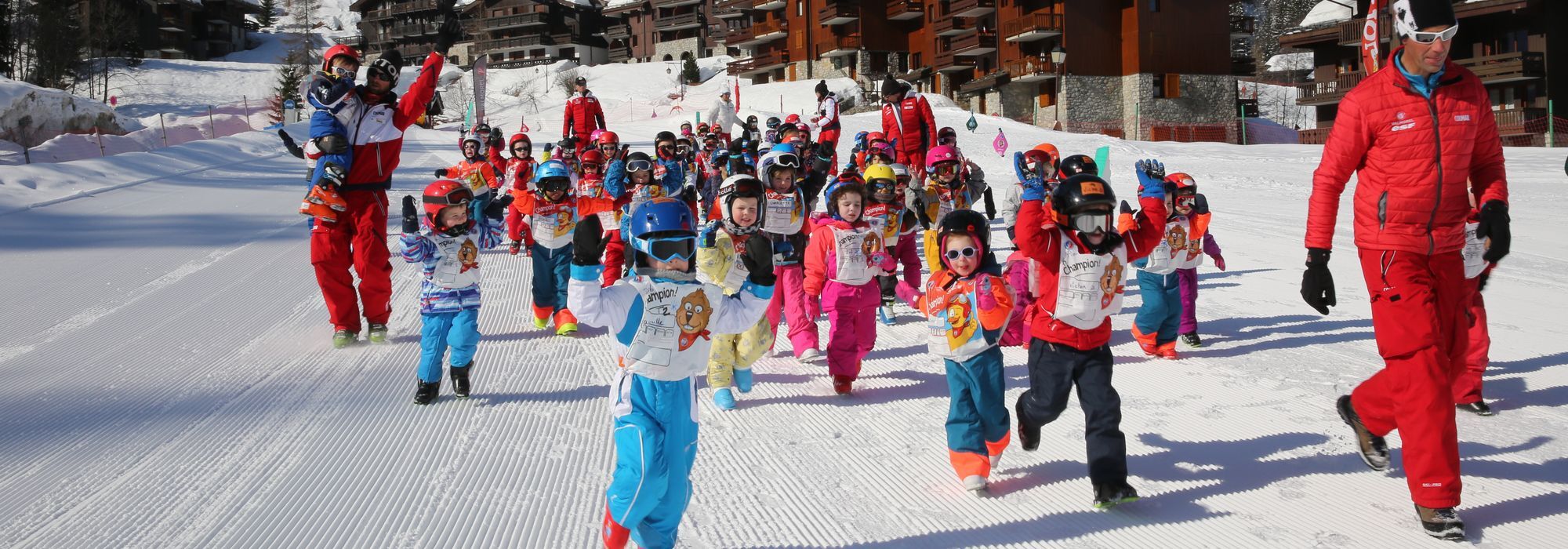 Children having fun during kids ski lessons at the Ski School ESF Valmorel's Club Piou Piou.