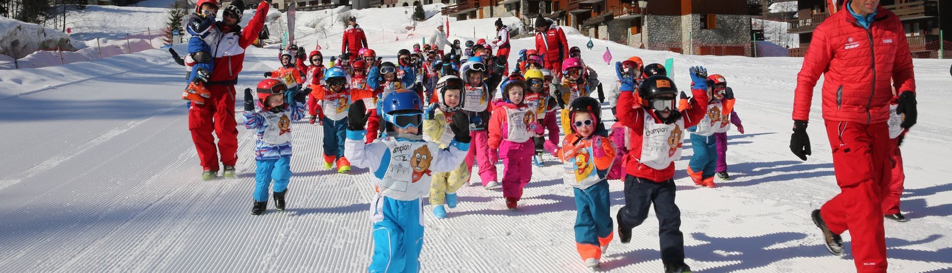 Children having fun during kids ski lessons at the Ski School ESF Valmorel's Club Piou Piou. 