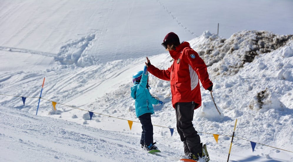Kid having fun in Pragelato during one of the private snowboarding lessons for kids of all levels. 