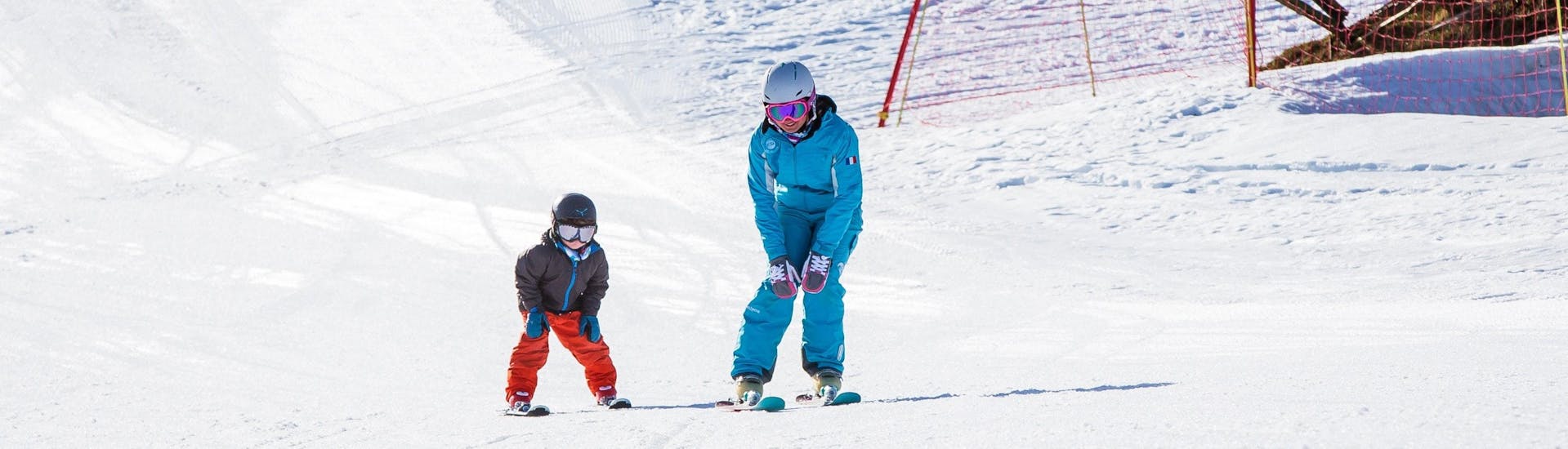An instructor and his student schuss during a private ski lesson for kids with the Ski School ESI Ski Family in Chamonix. 