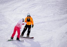 An instructor and snowboarder practising during their Private Snowboarding Lessons for Kids & Adults of All Levels with HSKI Zakopane.