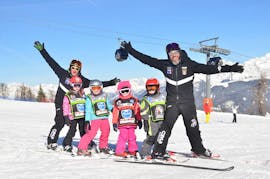 Kids and ski instructors having fun in Plan de Corones during one of the kids ski lessons for all levels.