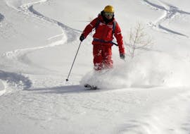 An instructor from the ski school ESF Ceillac leads the way in the powder during teen and adult ski lesson for all levels. 