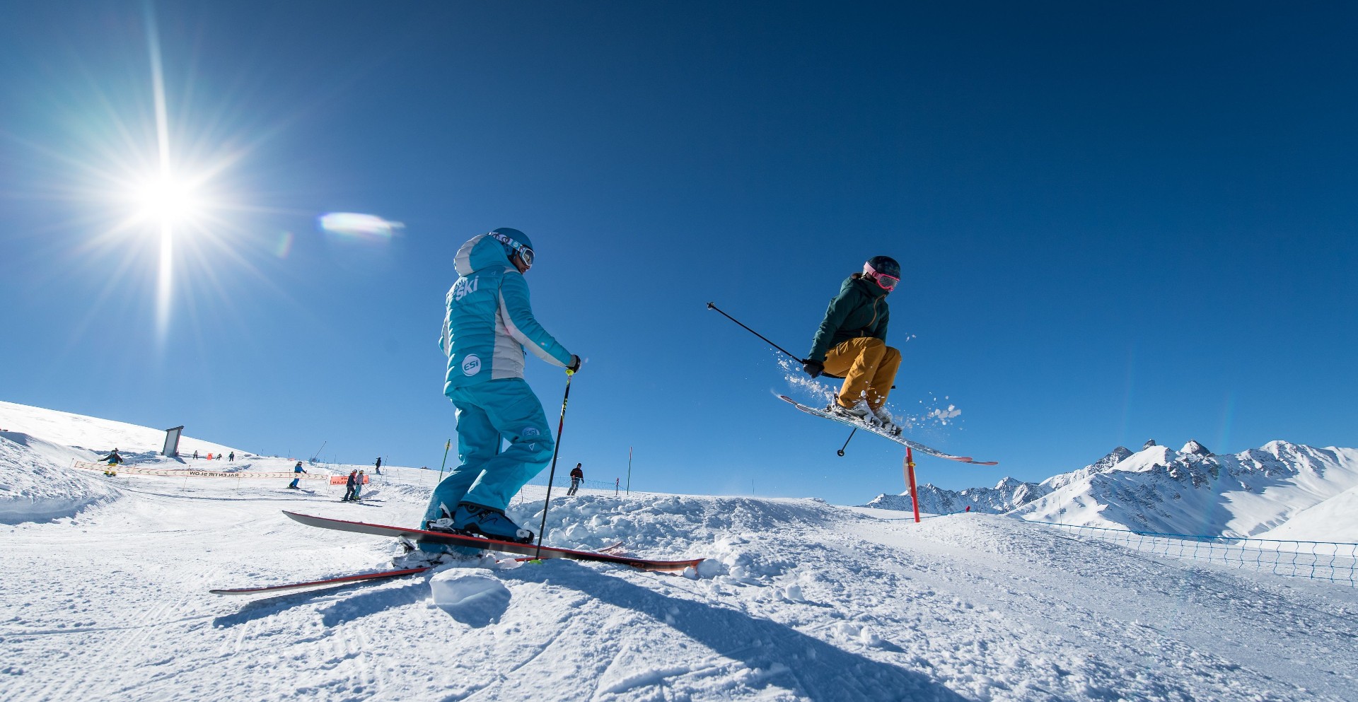 A skier practices freestyle with his  instructor of the ski school ESI Ski Family during private ski lessons for adults in Grand Bornand.
