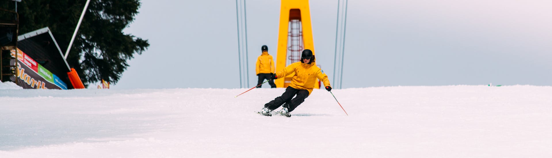 A skier is skiing down a slope at Adult Ski Lessons for All Levels.