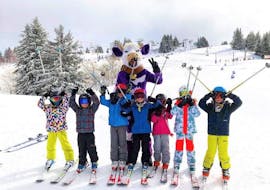 A group of children have fun with their instructor in Morzine during their kids ski lessons for all levels with the PDS Snowsports ski school.