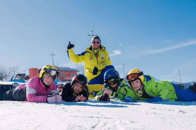Kids and snowboard instructor are ready for another snowboarding lessons for kids and adults of all levels in Asiago. 