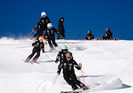 Lezioni di sci per bambini (6-11 anni) per sciatori con esperienza con Giorgio Rocca Ski Academy Crans-Montana.