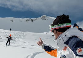 Ski instructor communicating via radio with a participant of the kids ski lessons for all levels academy pro in Madonna di Campiglio. 