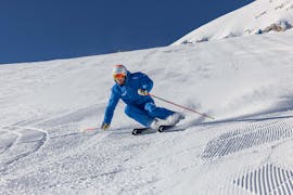 Ein Skifahrer der Skischule Skipower Finkenberg rast während seinem privaten Skikurs für Erwachsene für alle Levels die Pisten in Finkenberg hinunter.