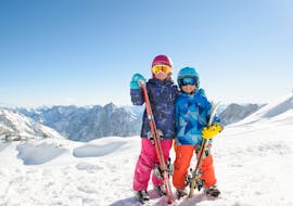 Happy kids during one of the kids ski lessons for skiers with experience in Abetone.
