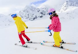 Kid and ski instructor during one of the private ski lessons for kids of all levels in Abetone. 